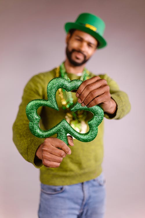 Close-Up Shot of a Person Holding a Shamrock