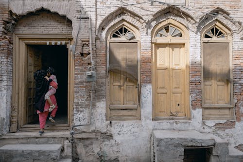 Photo of a Woman Carrying a Child 