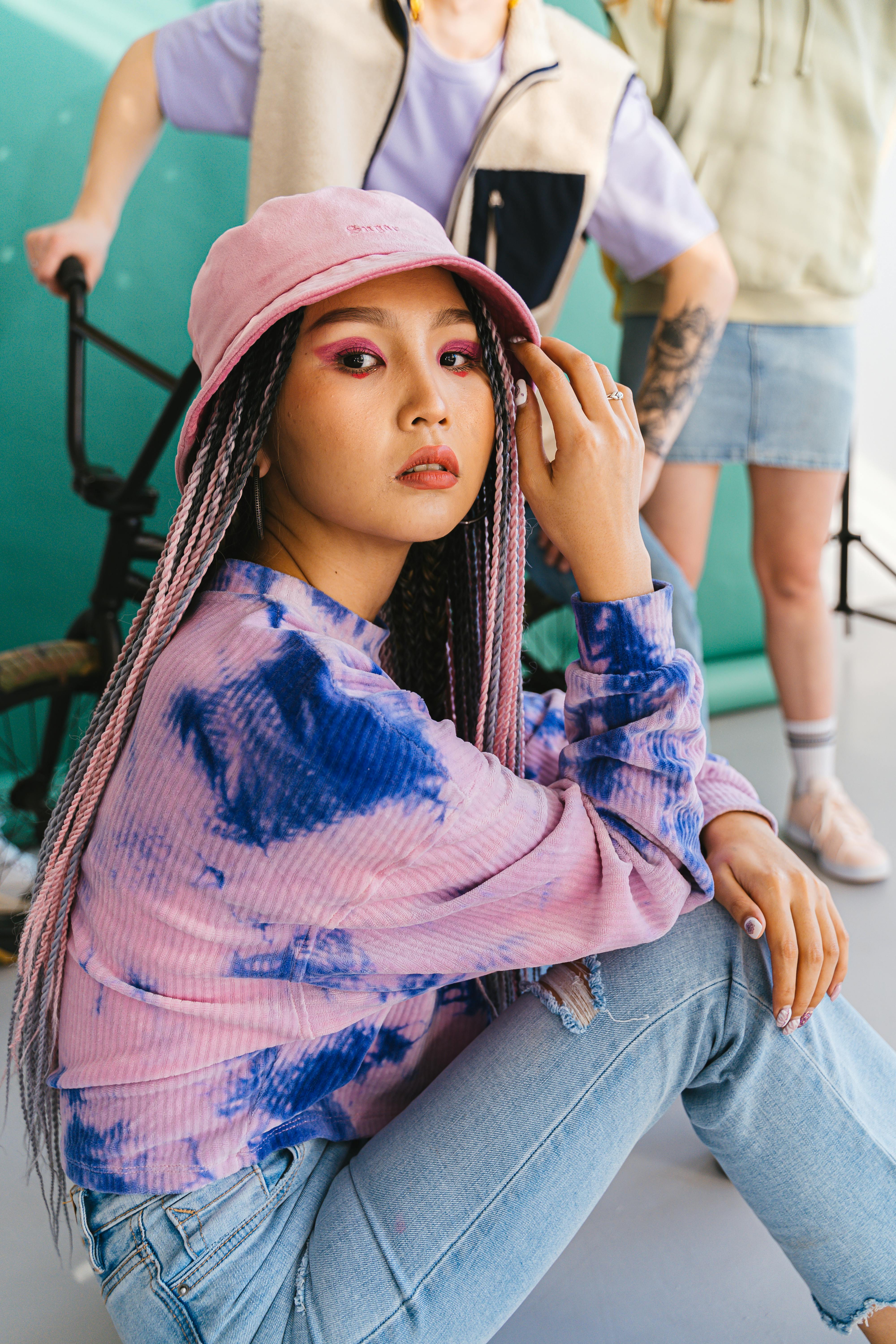 Woman Wearing Pink Bucket Hat Sitting on the Floor · Free Stock Photo