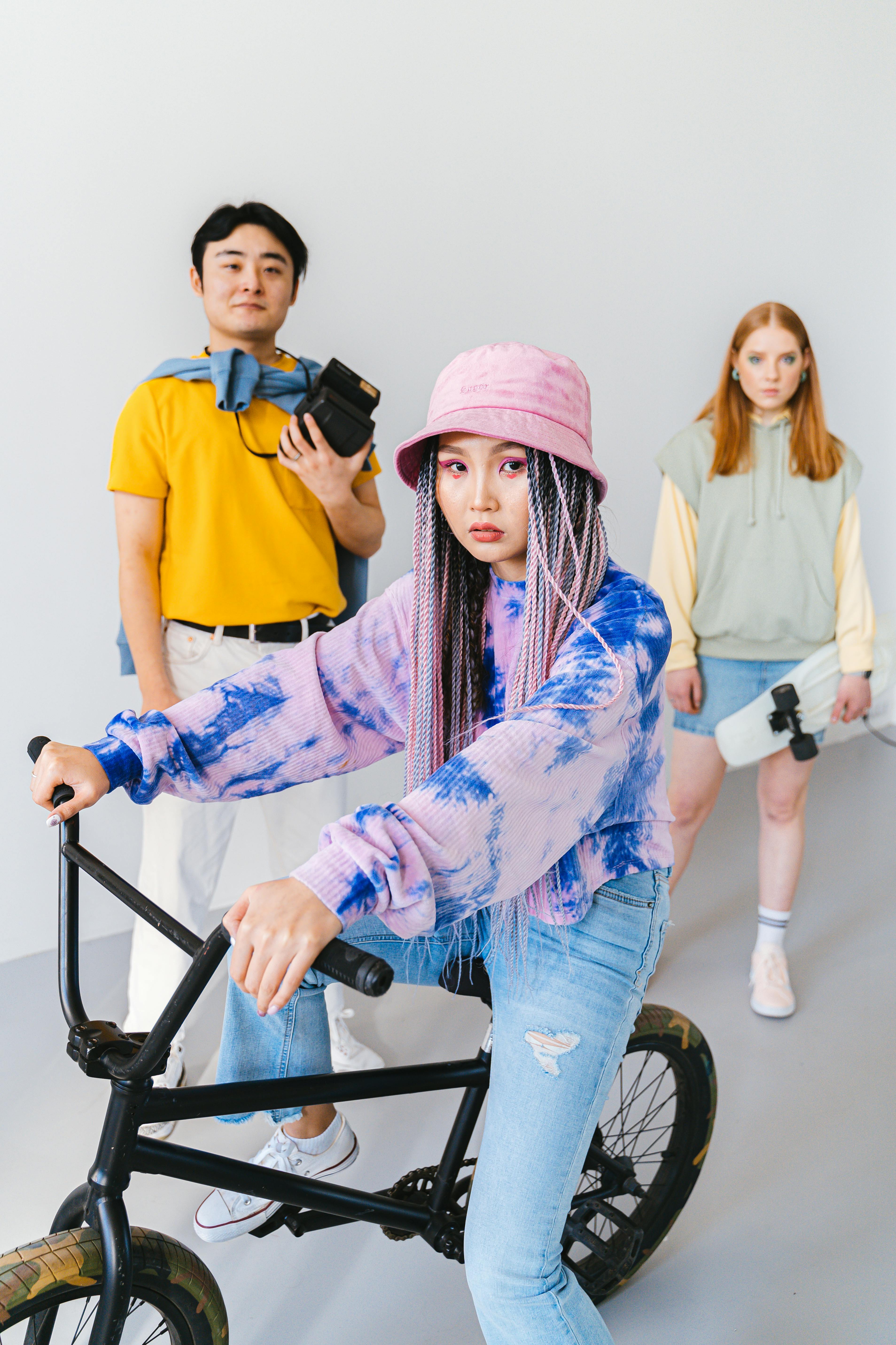 a woman riding a bmx bike near her friends