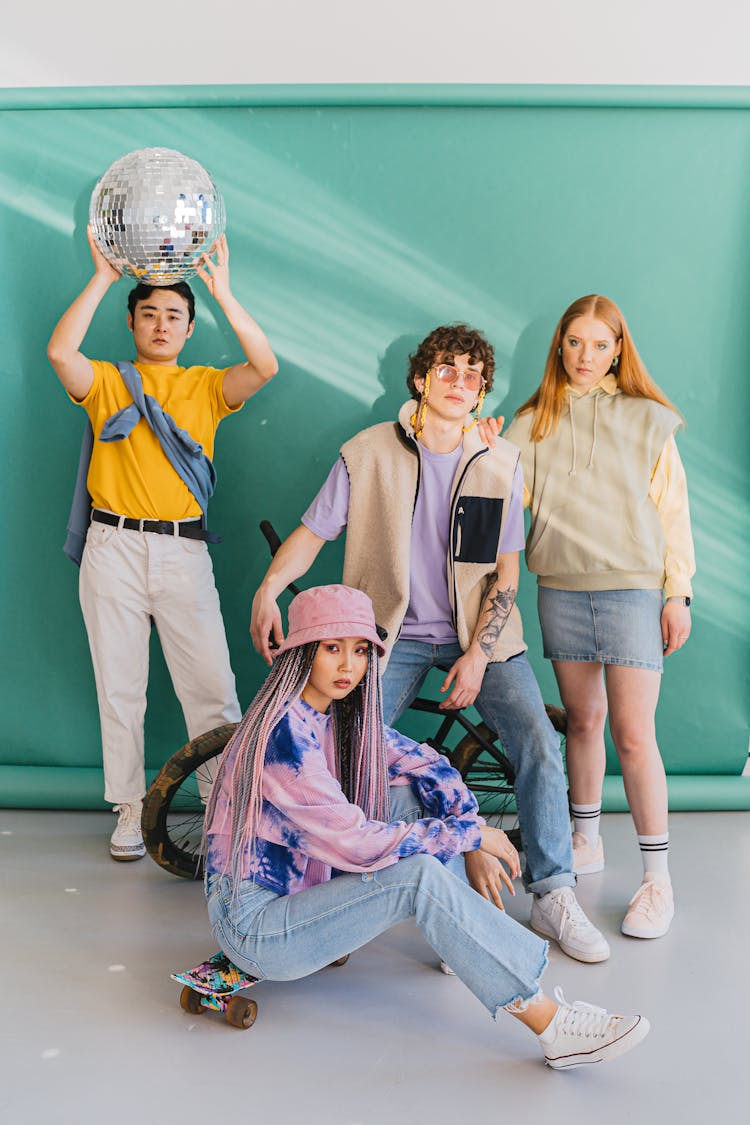 A Group Of People Posing In Front Of Backdrop
