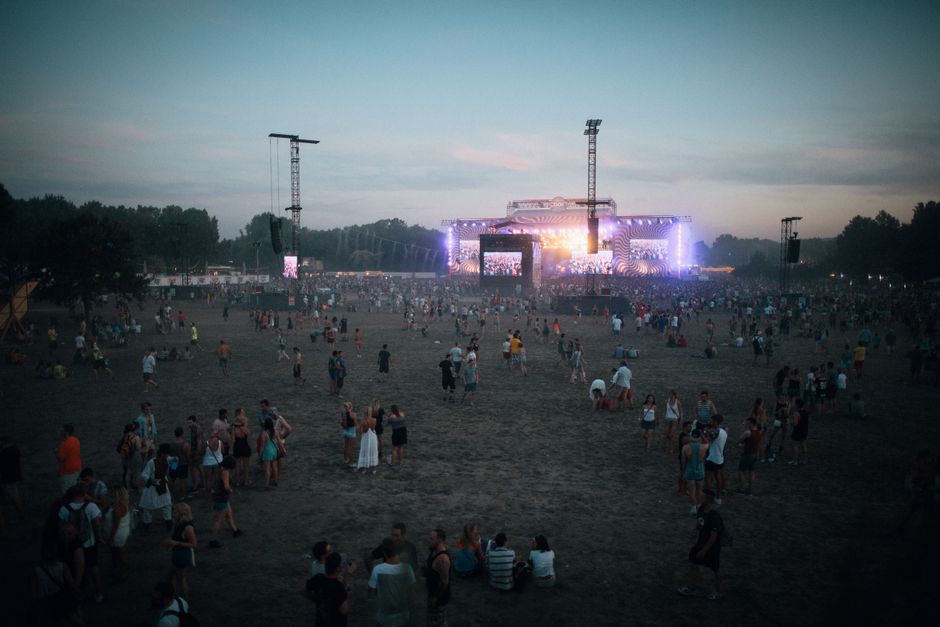 Vibrant outdoor concert scene with a lively crowd in Budapest during dusk.