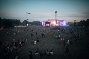 Open-air concert seen across a field, by Bence Szemerey on Pexels
