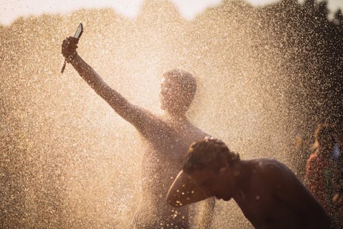 Men Playing in Splashing Water