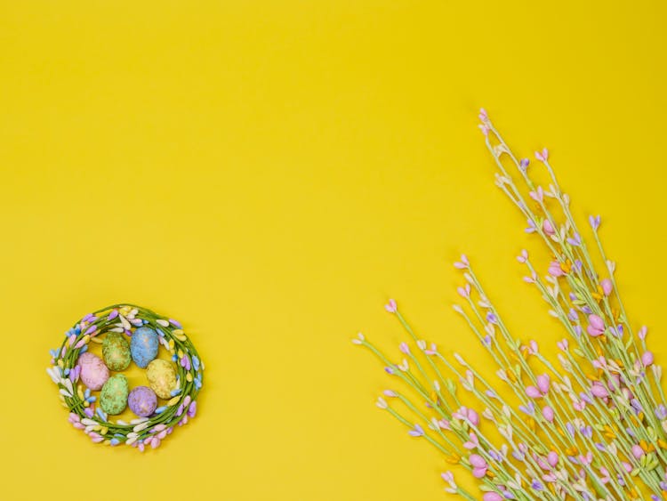 Pastel Colored Easter Eggs In A Colorful Straw Nest