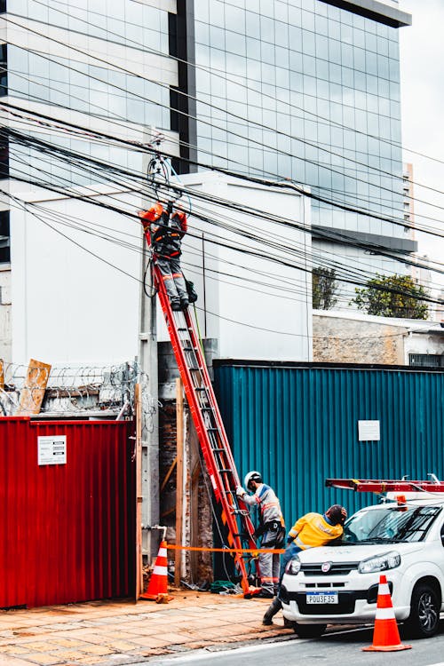 Men Working on Electric Posts Along the Road