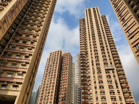 A stunning low-angle view of urban skyscrapers reaching into a clear blue sky, showcasing modern architecture.