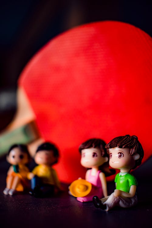 Free Couples figurines near red racket Stock Photo