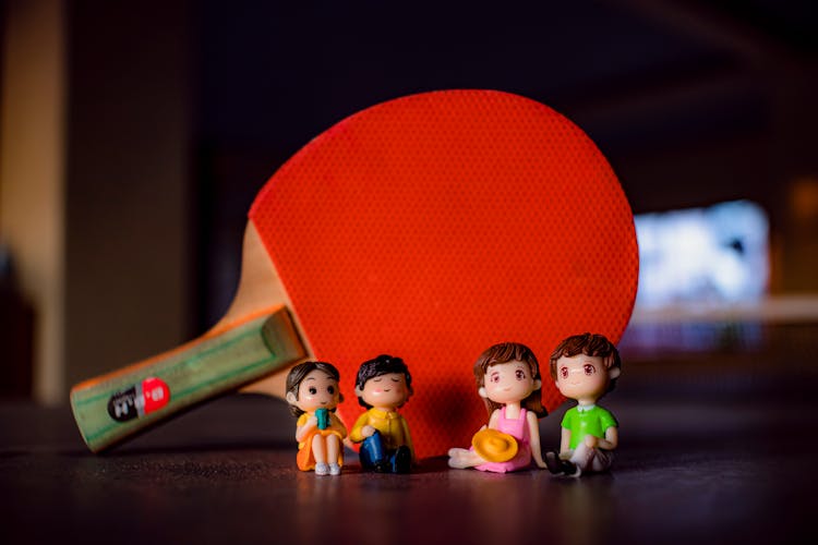 Figurines Near Ping Pong Racket