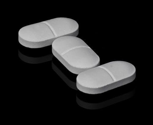 Free Close-up Photo of White Pills on Black Surface  Stock Photo