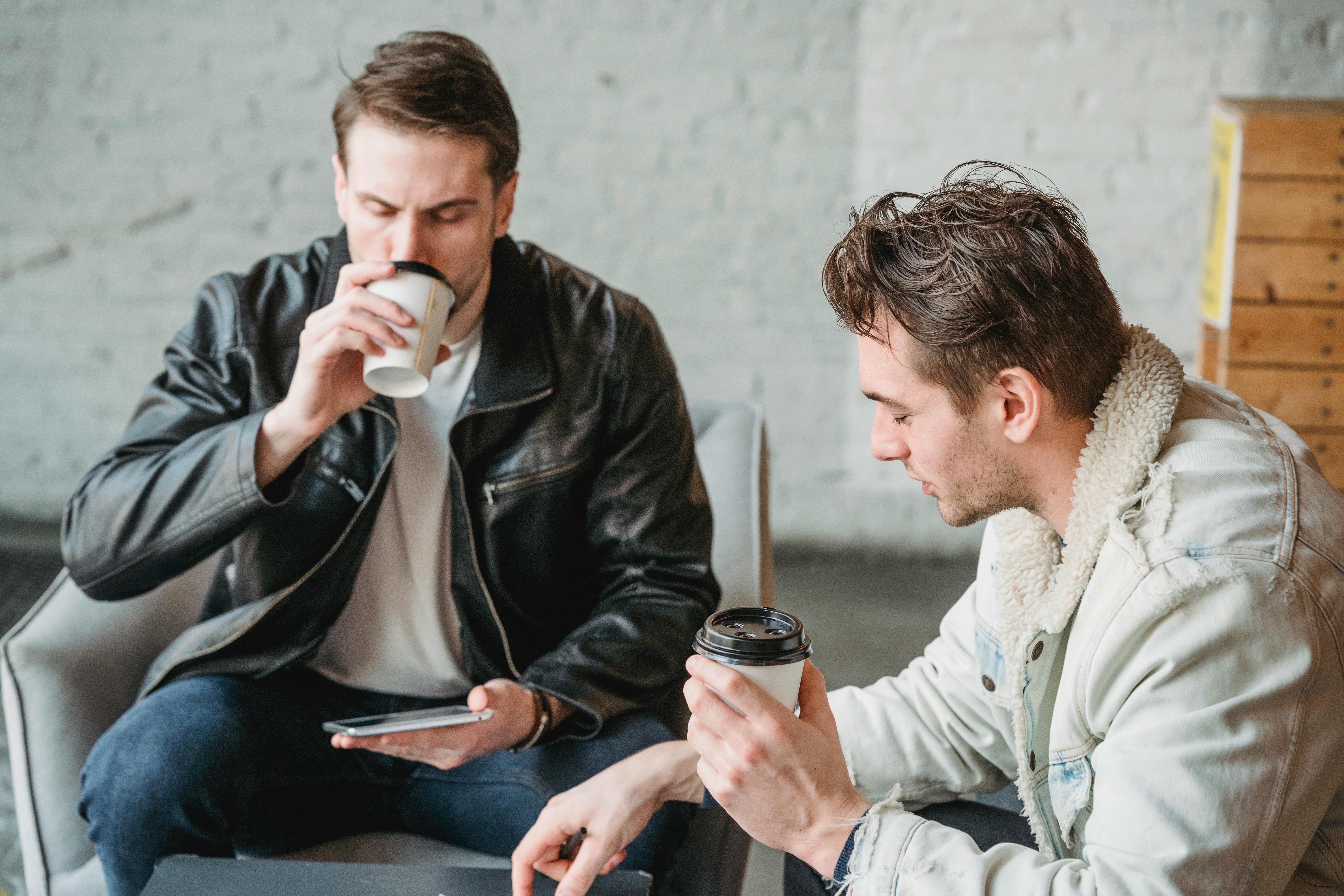 friends sitting together and drinking coffee