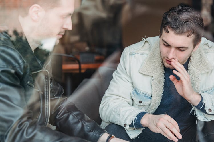 Male Colleagues Discussing Business Plans In Cafe