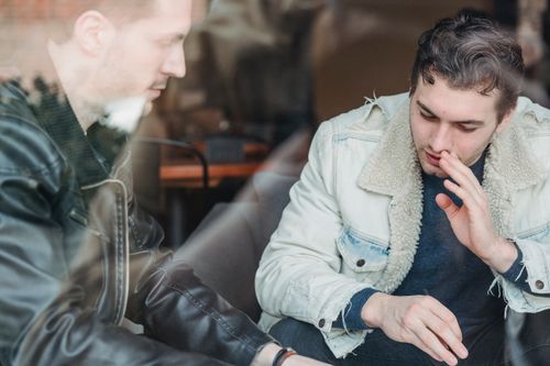 Free Through glass of business partners in casual wear talking about business strategy while working in cafe Stock Photo