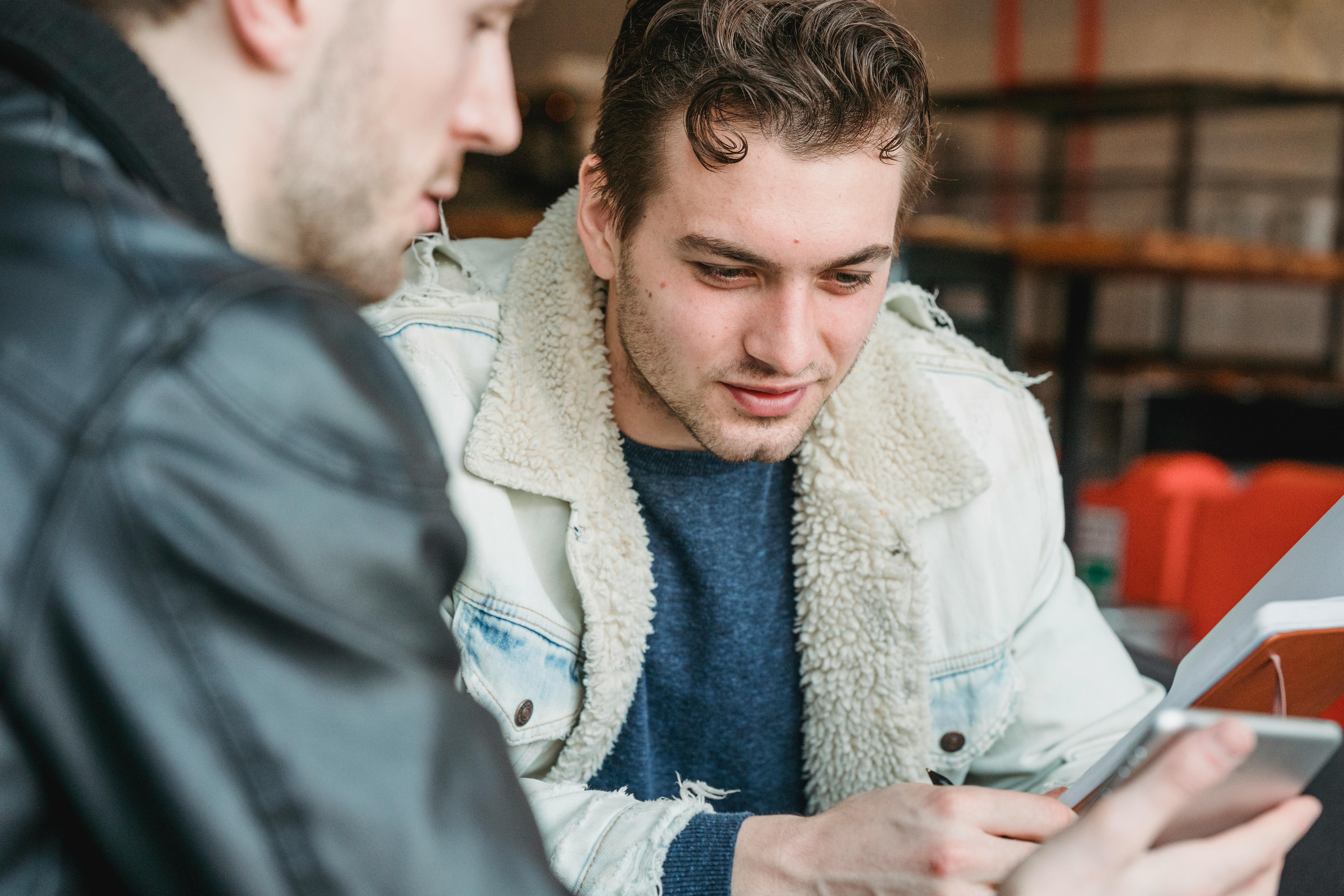 man reading information on tablet during work with partner