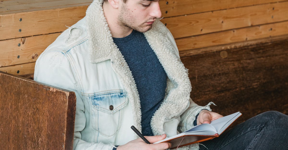 Serious man reading notes in notebook · Free Stock Photo