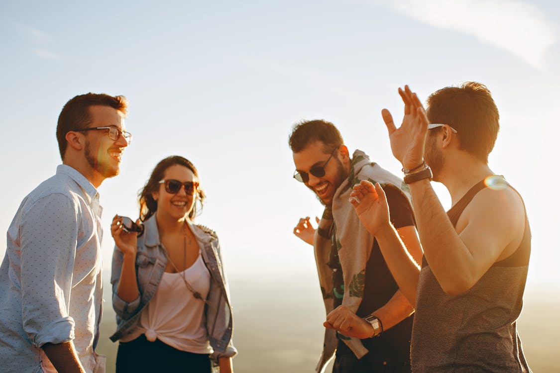 Free Group of People Having Fun Together Under the Sun Stock Photo