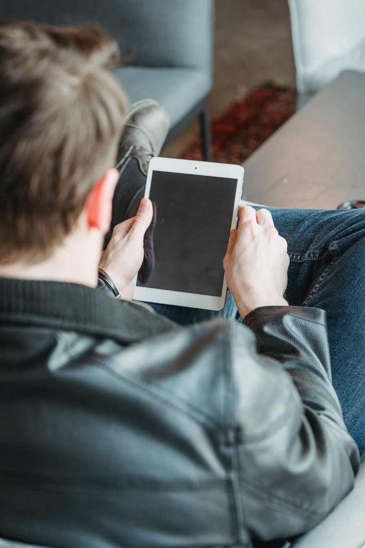 Man Browsing Tablet With Black Screen