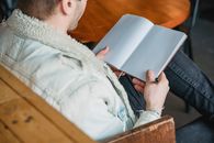 Man with opened empty planner near table