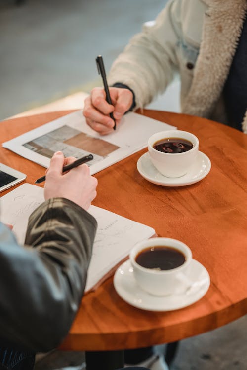 Businessmen signing contract table with coffee