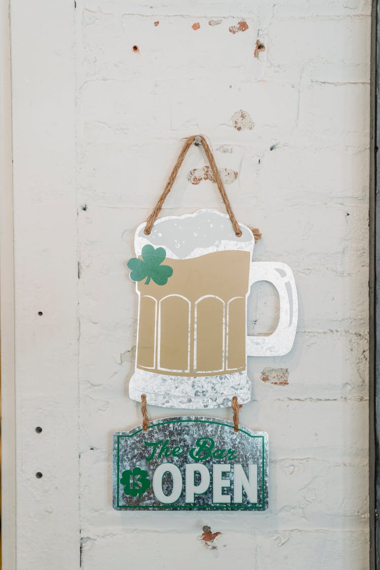 Old Signboard With Glass Of Beer And Clover Saying Open