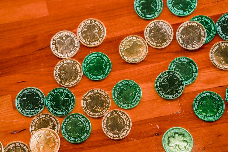 Many St Patricks Day Coins Placed On Brown Wooden Floor