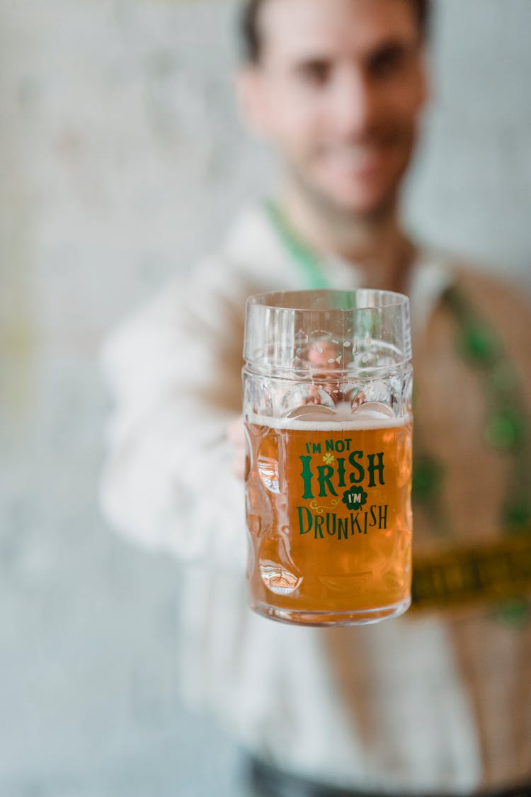 Happy Man Demonstrating Glass With Irish Beer