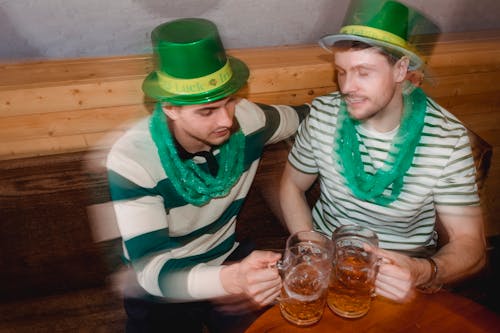 Drunk friends with beer celebrating St Patricks Day in pub