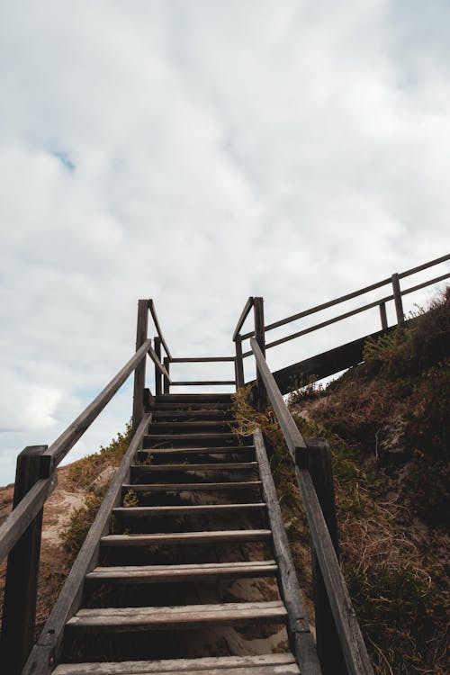 Wooden staircase on stony cliff slope