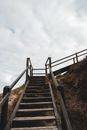 Wooden staircase on stony cliff slope