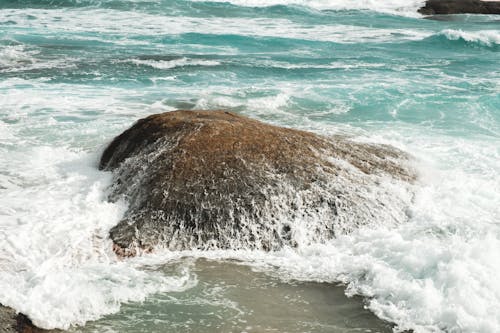 Azure foamy sea washing stony coast