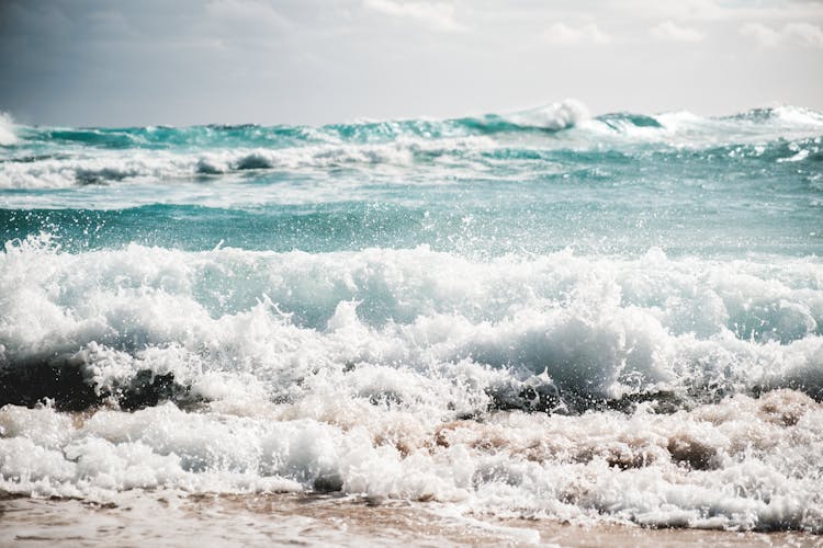 Stormy Azure Sea Rolling On Sandy Shore