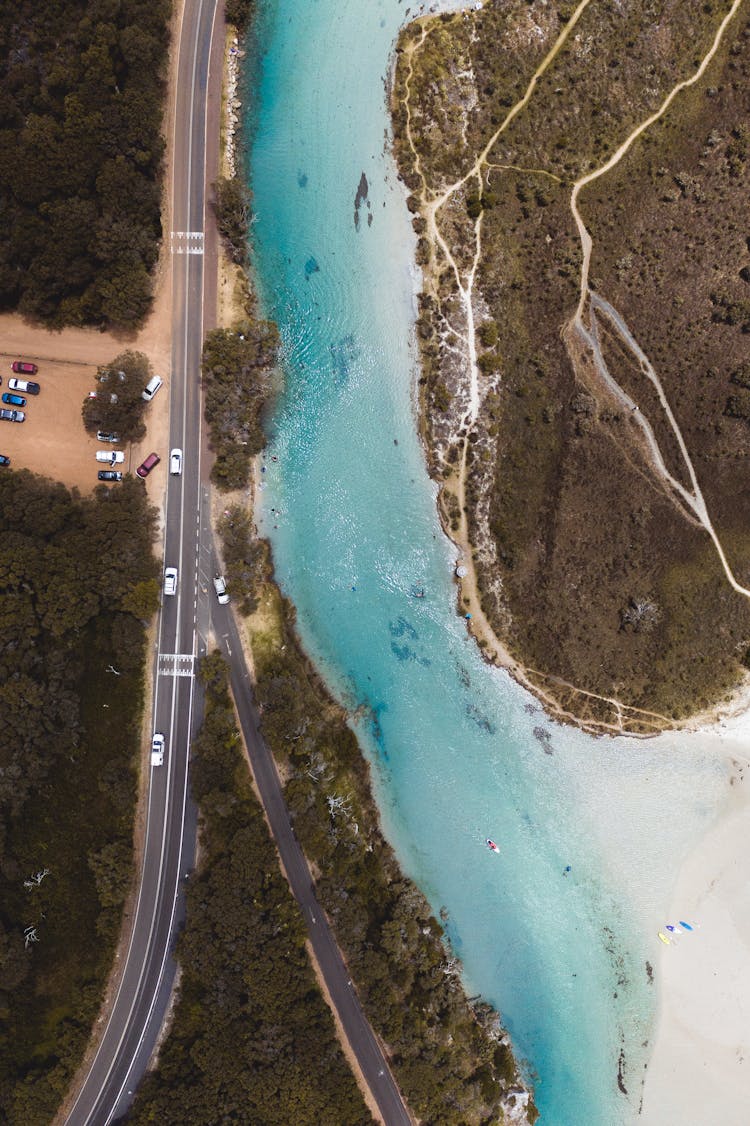 Cars Rushing On Narrow Asphalt Road Near River