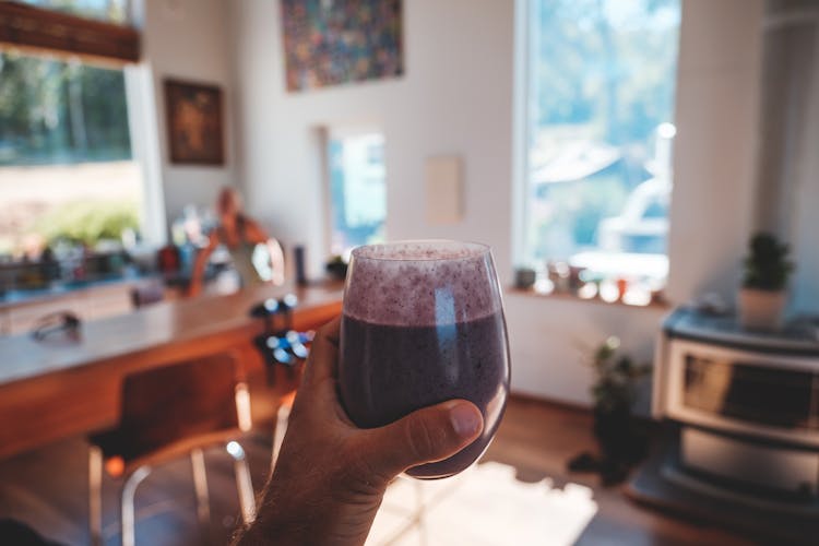 Person With Glass Of Fresh Smoothie At Home