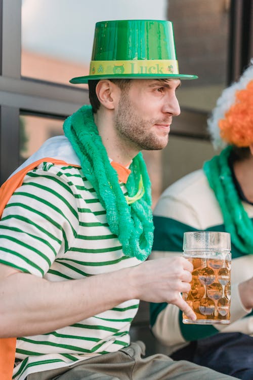 Free Man in festive clothes with beer during Saint Patricks day Stock Photo