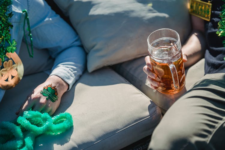 Crop Faceless Male Friends Drinking Beer During St Patricks Day Party