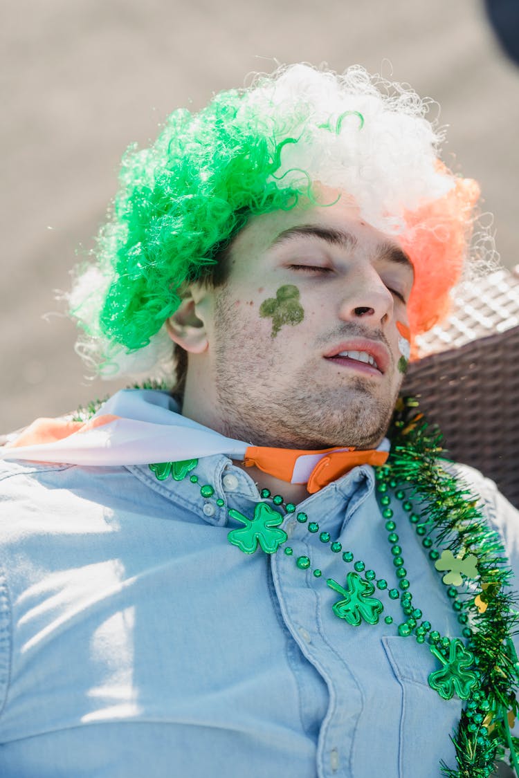 Drunk Young Man In Irish Flag Wig Sleeping On Couch After Arty