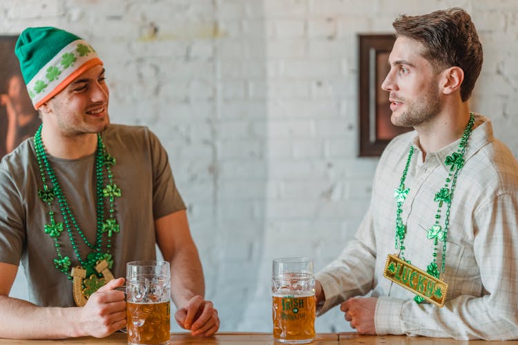 Cheerful Football Fans Drinking Beer In Pub And Talking