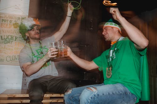 Happy friends celebrating national holiday drinking beer