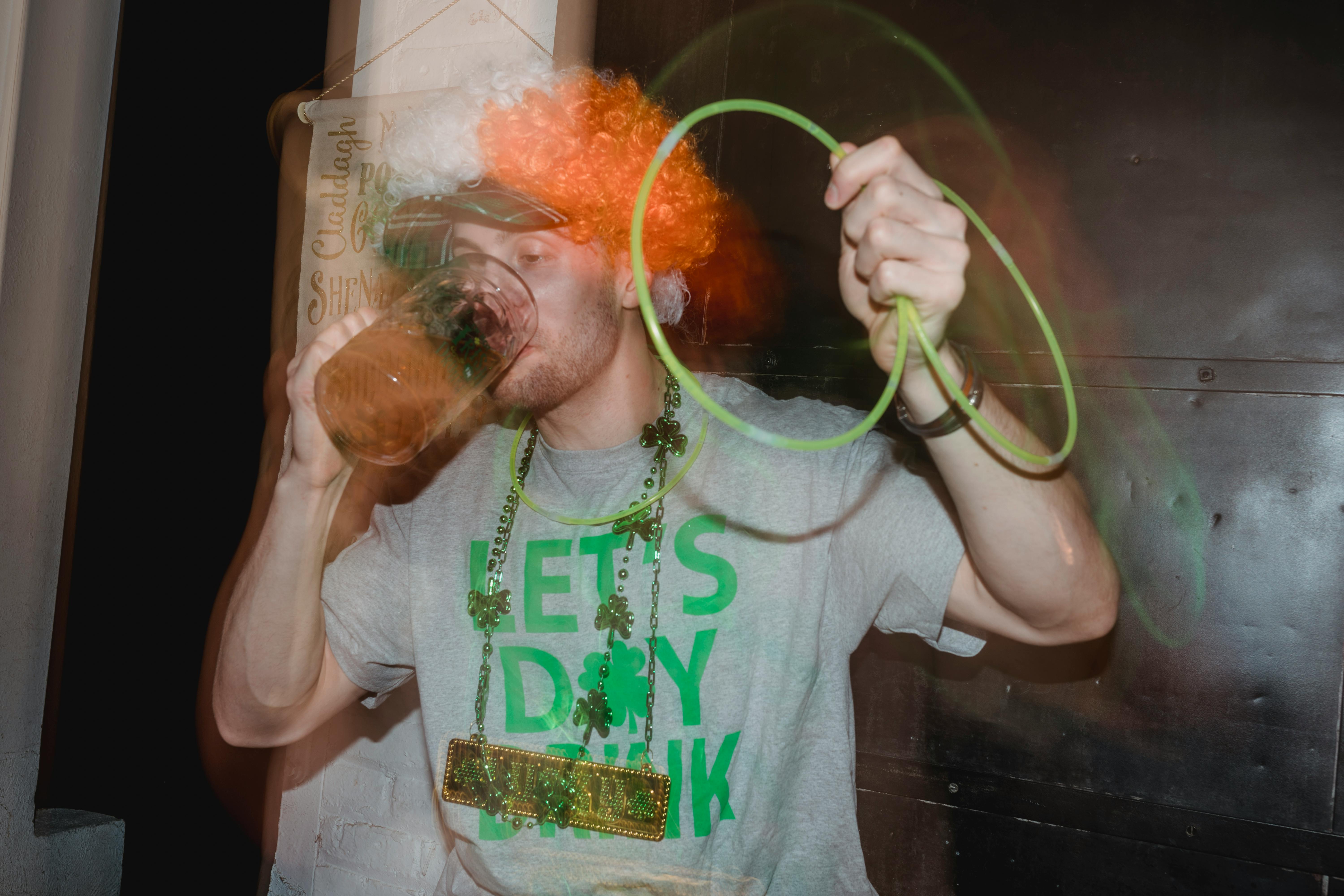 happy young man drinking beer at party