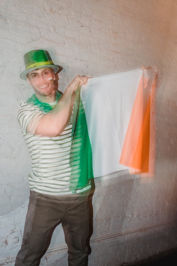 Cheerful Male Hanging Flag Of Ireland