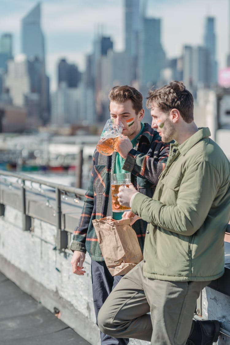 Friends Drinking Beer And Eating Fast Food Staying In The Street