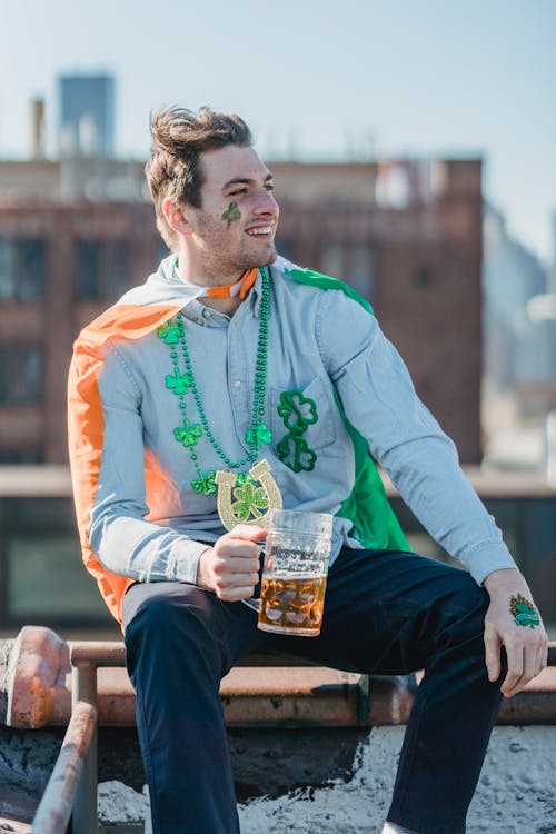 Content guy boozing beer and smiling during celebration of St Patricks Day