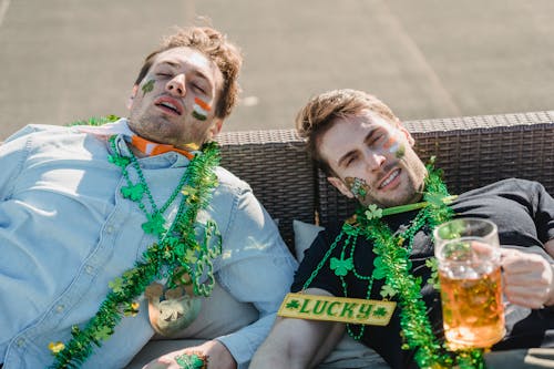 Free Drunk guys chilling on sofa after celebration of St Patricks Day Stock Photo