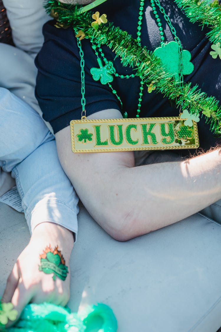 Crop Unrecognizable Guys In Lying On Couch After St Patricks Day Party