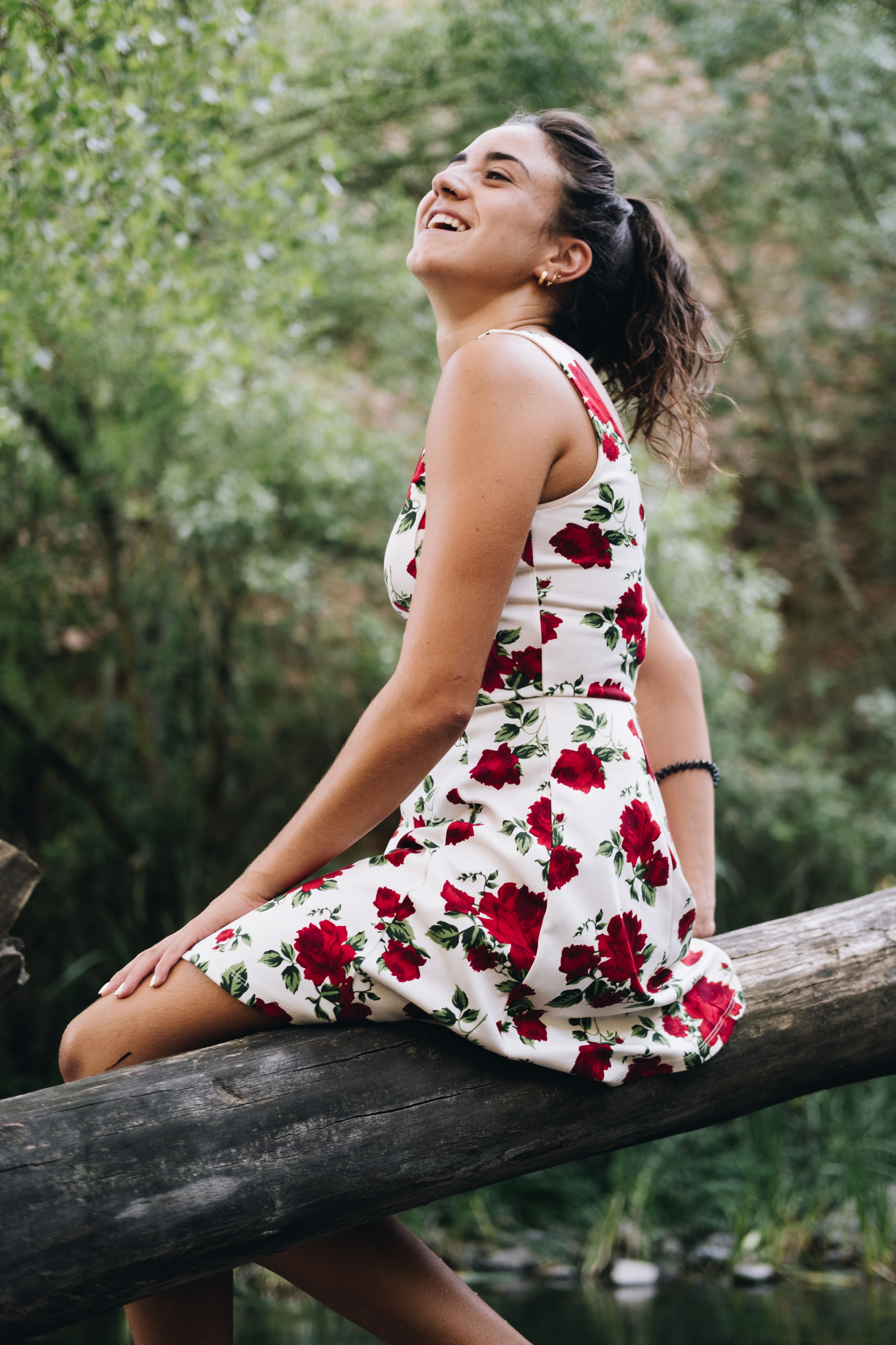 Woman Wearing a Floral Dress Sitting on a Log · Free Stock Photo