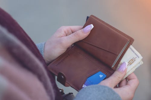 Close-Up Shot of a Person Holding a Brown Wallet
