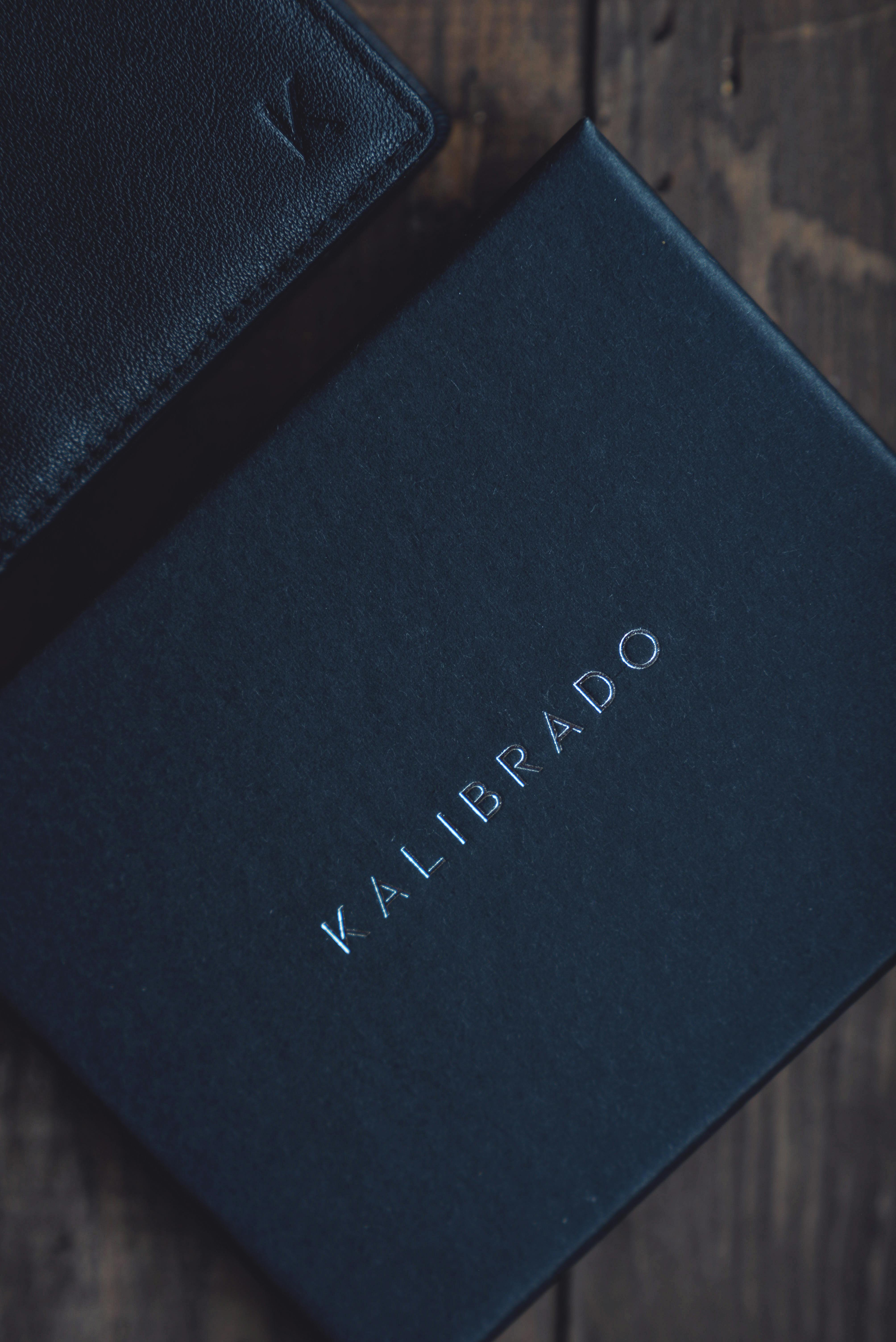 Black Leather Bifold Wallet on Top of Macbook · Free Stock Photo