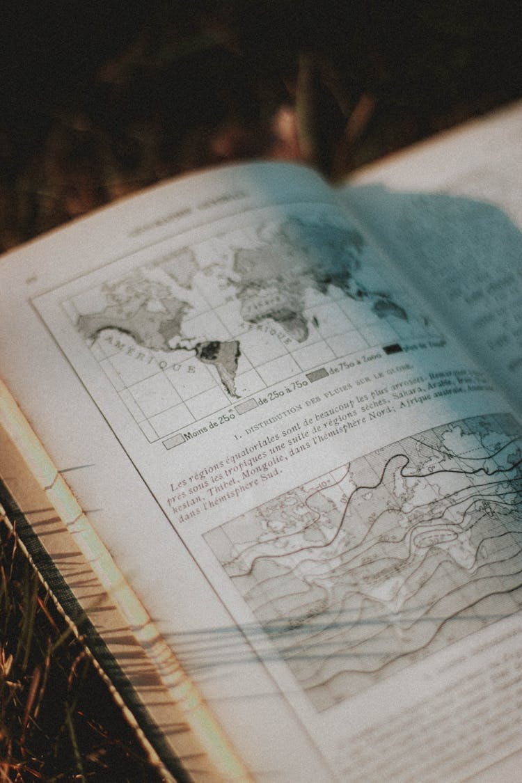 Old Book With Map Illustration In Sunlight