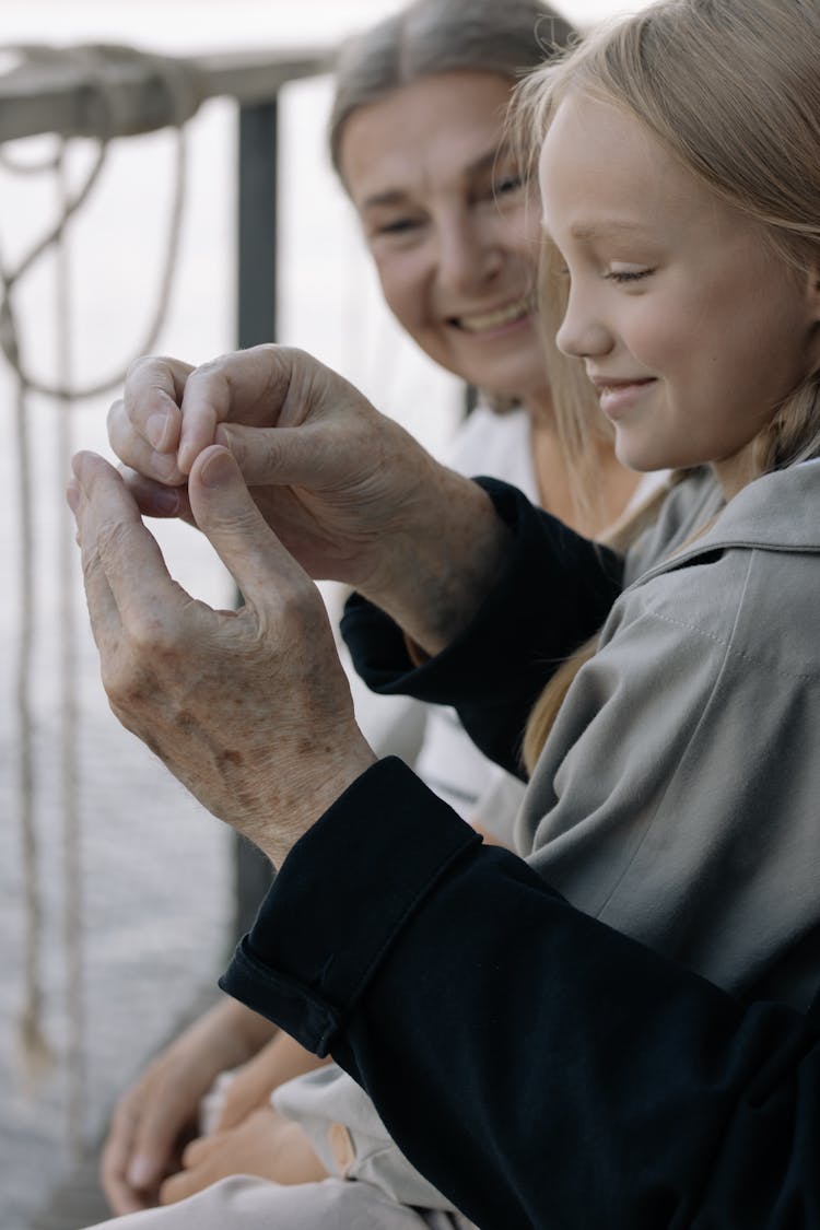 Girl In Gray Long Sleeve Shirt Sitting With Her Grandparents