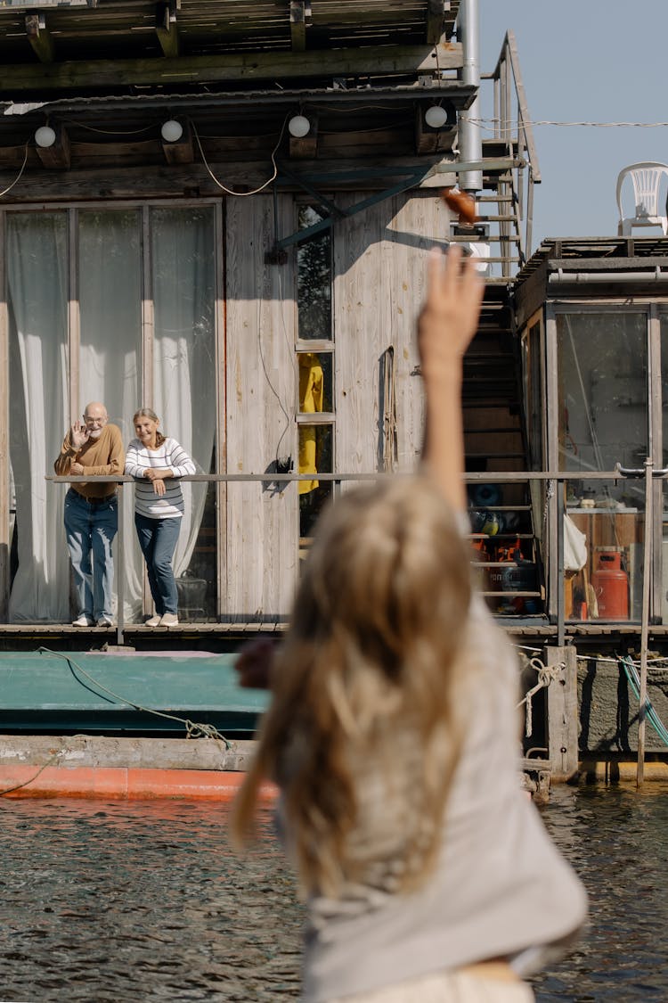 Child Waving To Her Grandparents